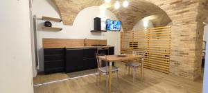 a kitchen with a table and chairs in a room at Appartamento di Porta Maggiore in Cupra Marittima