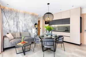 a living room with a couch and a table at Fly Apartments Medulin - 50m from the Beach - NEW 2024 in Medulin +21 photos
