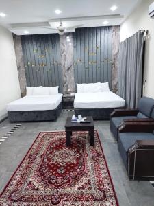 un soggiorno con 2 letti e un tappeto di Rose Valet Guest House a Islamabad