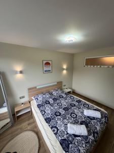 a bedroom with a bed with a quilt on it at Sea Treasure in Varna City