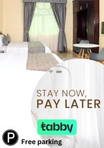 a bedroom with a bed and a sign that says stay now pay later at Al BARAKAH HOTEL in Sharjah
