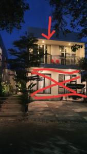 a building with a red sculpture in front of it at Malang and Bromo Tour Riverside in Malang