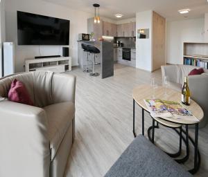 a living room with a couch and a table at Fewo 61 Hogwarts in Sagard