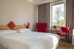 Ένα ή περισσότερα κρεβάτια σε δωμάτιο στο Hotel Parc Belle-Vue