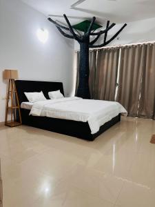 a bedroom with a bed with a tree in it at Elite stays viman nagar in Pune