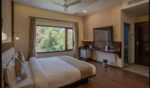 a bedroom with a large bed and a large window at Hotel Stay Casa in Bhopal +64 photos