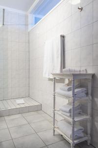 a bathroom with a towel rack and a shower at Hotel Parc Belle-Vue in Luxembourg