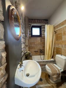 La salle de bains est pourvue d'un lavabo et de toilettes. dans l'établissement Mansion Michalis, à Rodavgi