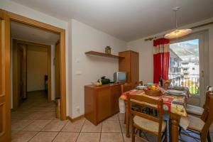 a kitchen with a table and a dining room at Résidence Jardins d'Androsace 17 - Happy Rentals in Chamonix-Mont-Blanc