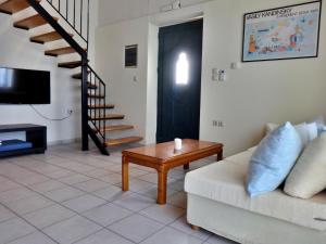 a living room with a couch and a table at Thalassa Apartments in Rethymno