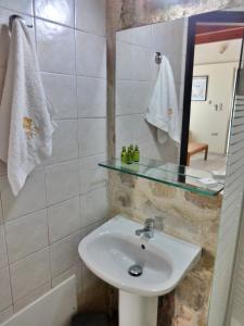 a bathroom with a sink and a mirror at Thalassa Apartments in Rethymno +51 photos