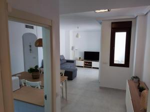a living room and dining room with a blue couch at Urbanización Altos de Nuevo Vera in Vera +36 photos