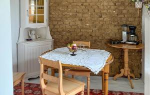 a dining room table with a bowl of fruit on it at 3 Bedroom Lovely Home In Skillinge in Skillinge