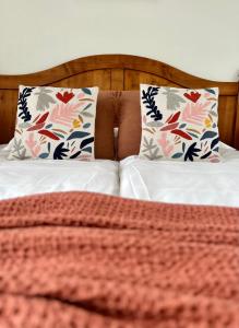 a bed with two pillows on top of it at L'Isly, Dernier étage en centre de Rennes avec terrasse de 50m2 in Rennes +10 photos