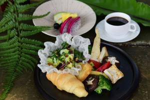 a plate of food with a salad and a cup of coffee at Fusen Purifying in Toucheng