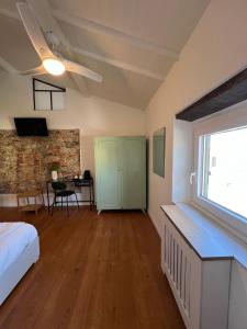 a bedroom with a bed and a window and a table at La Matilde in Viareggio