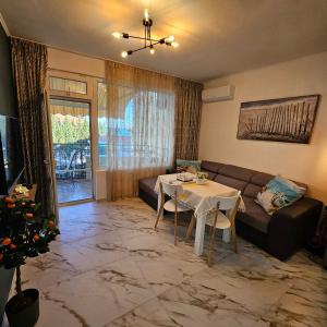 a living room with a couch and a table at LaRenta Sveti Vlas, ulitsa Cherno more 12 in Sveti Vlas