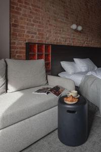 a living room with a couch and a bed at Resume apartments, Dreamer Corner No1 by Urban Rent in Kaunas