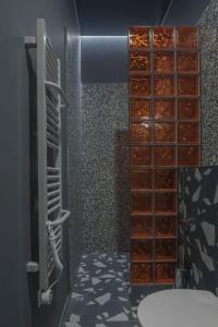 a bathroom with a walk in closet with wooden shelves at Resume apartments, Dreamer Corner No1 by Urban Rent in Kaunas