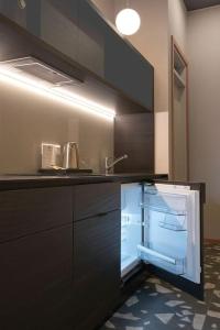 an empty kitchen with a sink and a refrigerator at Resume apartments, Dreamer Corner No1 by Urban Rent in Kaunas