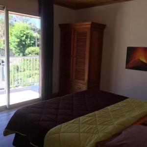 1 dormitorio con cama y ventana grande en Madeleine Rose en Cilaos