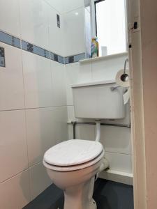 a white toilet in a bathroom with a window at Salisbury Place Professional Let in Bishop Auckland