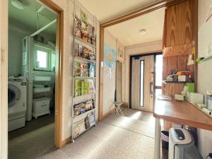 a laundry room with a washer and dryer at Guest House モモ in Obihiro