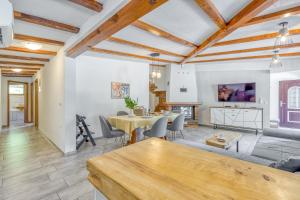 a living room with a table and a couch at Bajsova domačija in Podčetrtek