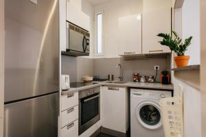 Kuchyň nebo kuchyňský kout v ubytování Cute Apartment