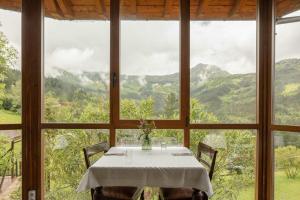 a table in a room with a view of mountains at Hotel & Spa Etxegana in Zeanuri