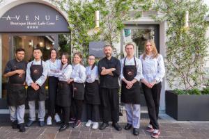 a group of people standing in front of a store at Avenue Boutique Hotel in Como