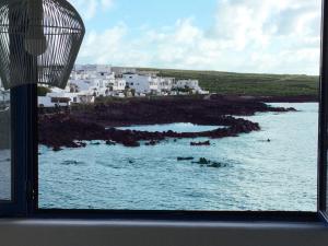 a view of the ocean from a window at Casa Costa Jameos in Punta de Mujeres