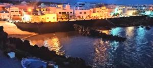 a view of a city at night at Casa Costa Jameos in Punta de Mujeres