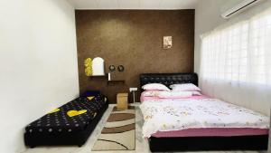a bedroom with a bed and a couch in it at PD Best Homestay in Port Dickson +65 photos