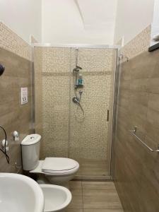 a bathroom with a shower and a toilet and sink at Vittorio Emanuele house in Catania