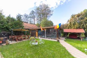 a house with a bike parked in the yard at Casa Nan cu Terasa - Castelul Bran in Bran