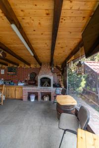 a living room with a brick fireplace and wooden ceilings at Casa Nan in Bran