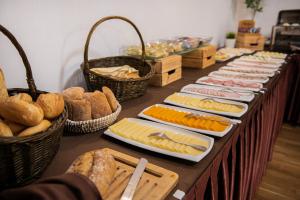 a table topped with lots of cheese and bread at Hotel "Na Uboczu" in Warsaw