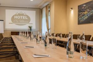 a conference room with a long table with wine bottles at Hotel "Na Uboczu" in Warsaw