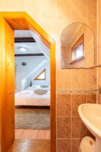 a bathroom with a bed and a sink in a room at Casa Nan in Bran