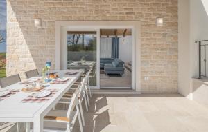 a dining room with a white table and chairs at Villa Paulina by SeeAdria Agency in Buje