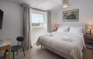 a bedroom with a bed with two towels on it at Villa Paulina by SeeAdria Agency in Buje +33 photos