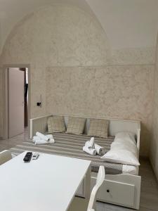 a bedroom with a bed with two white shoes on it at Vittorio Emanuele house in Catania