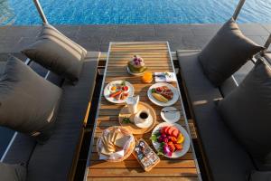 a table with food on it next to a pool at Villa W Luxury in Nai Harn Beach