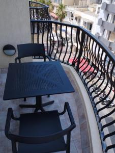 a patio with a table and chairs on a balcony at Perfect tourist accommodation in Bugibba square! in St Paul's Bay