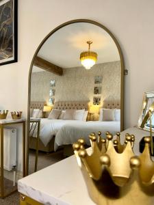 a bedroom with two beds and a large mirror at Fitzgeralds - Ballybunion - Sleeps 34 in Ballybunion