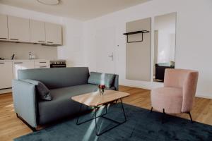 a living room with a couch and a table and a chair at Zur Pfanne – Studio in Biberach an der Riß