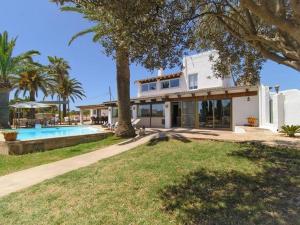 a large white house with a swimming pool in a yard at Ca sa Padrina in Colonia Sant Jordi