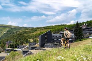 a person riding a bike on a hill at Belambra Clubs Superbesse - Le Chambourguet in Super Besse