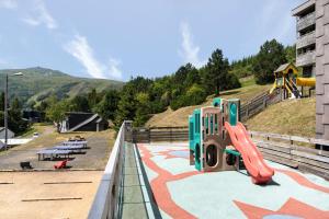 a playground with a slide on a hill at Belambra Clubs Superbesse - Le Chambourguet in Super Besse